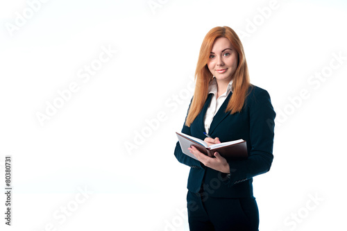 Red hair business woman writes in diary