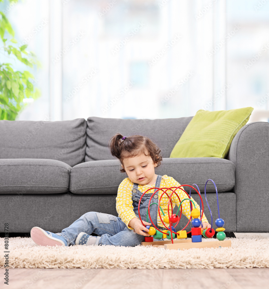 Cute baby girl playing with toy at home Cute baby girl playing with toy at home