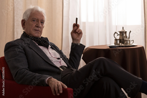 Photos Senior millionaire smoking cigar