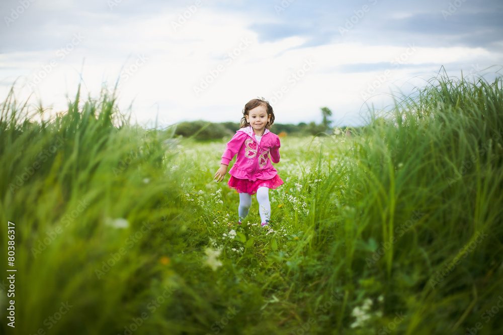 beautiful carefree girl playing outdoors in field beautiful carefree girl playing outdoors in field