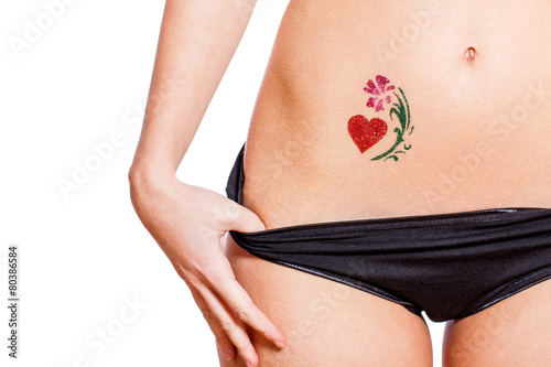 Woman with heart shaped glitter-tattoo isolated