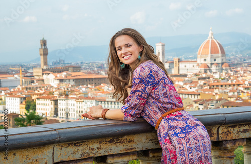 Portrait of happy young woman against panoramic view of florence © Alliance