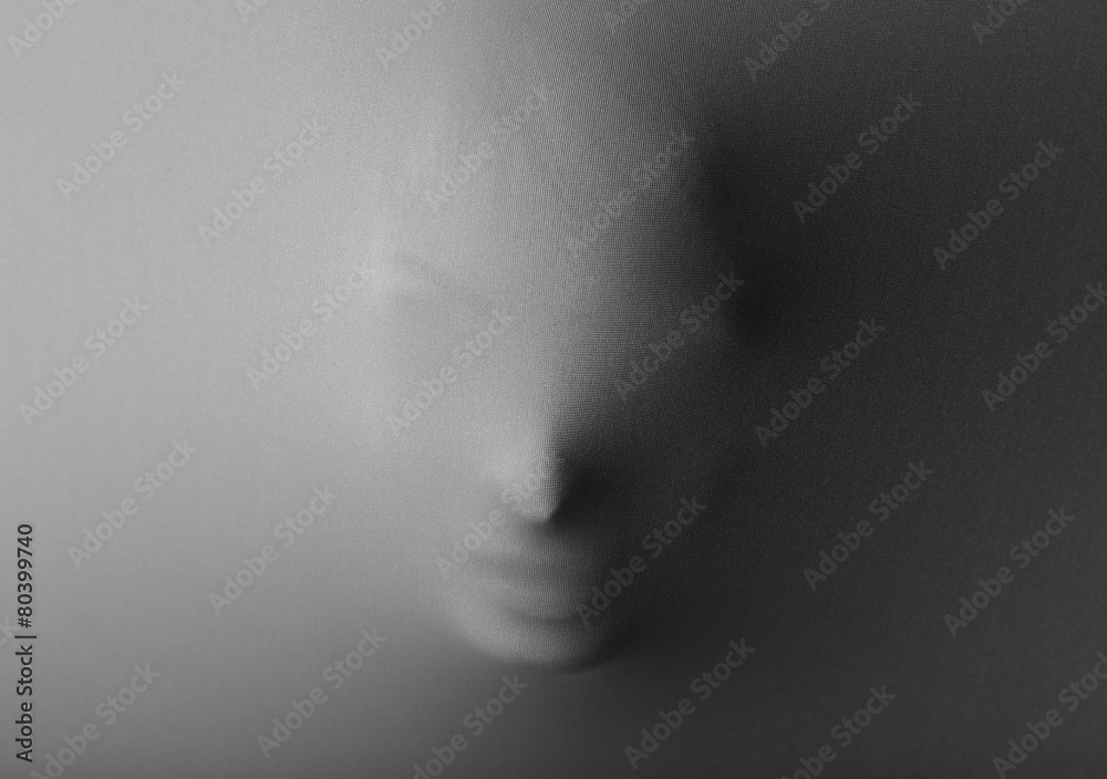 Obraz premium Screaming human face pressing through fabric as horror