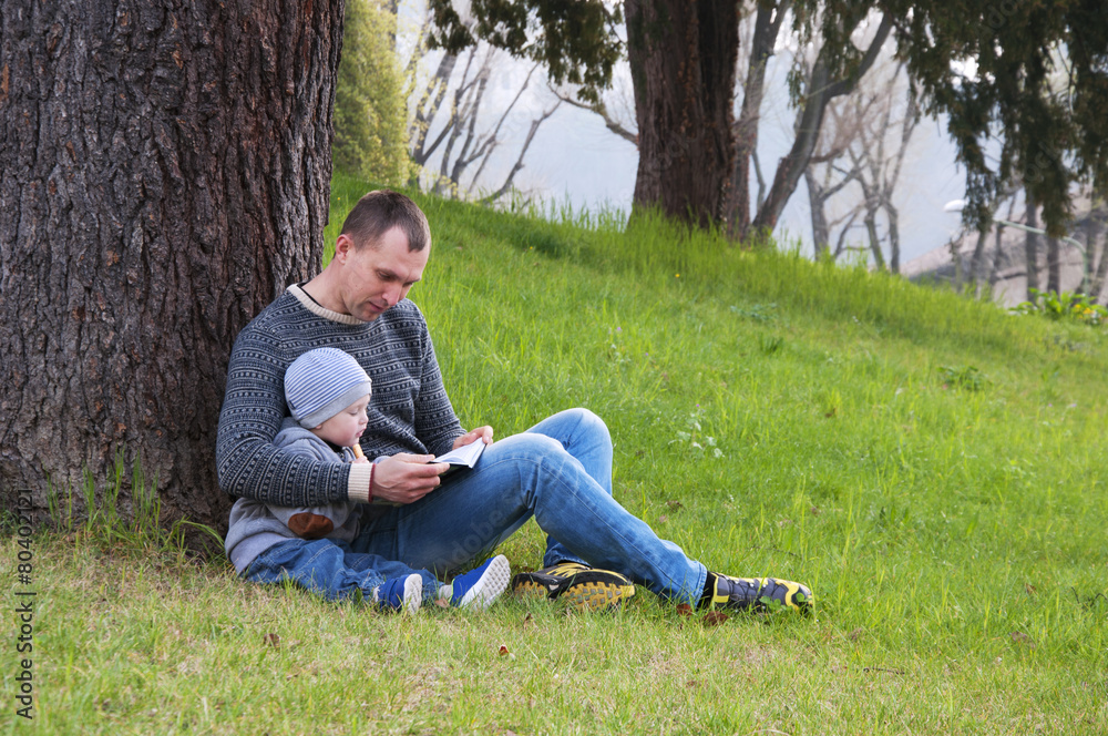 dad and son reading a book