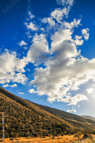 Hill and blue sky in New Zealand photo