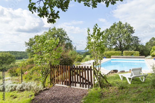 Landscaped pool with wooden fence and distant views