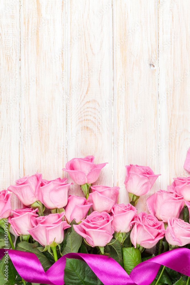 Pink roses bouquet over wooden table Pink roses bouquet over wooden table