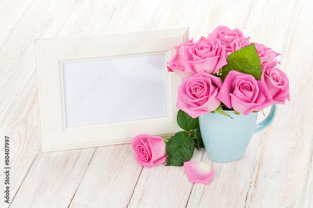 Blank photo frame and pink roses