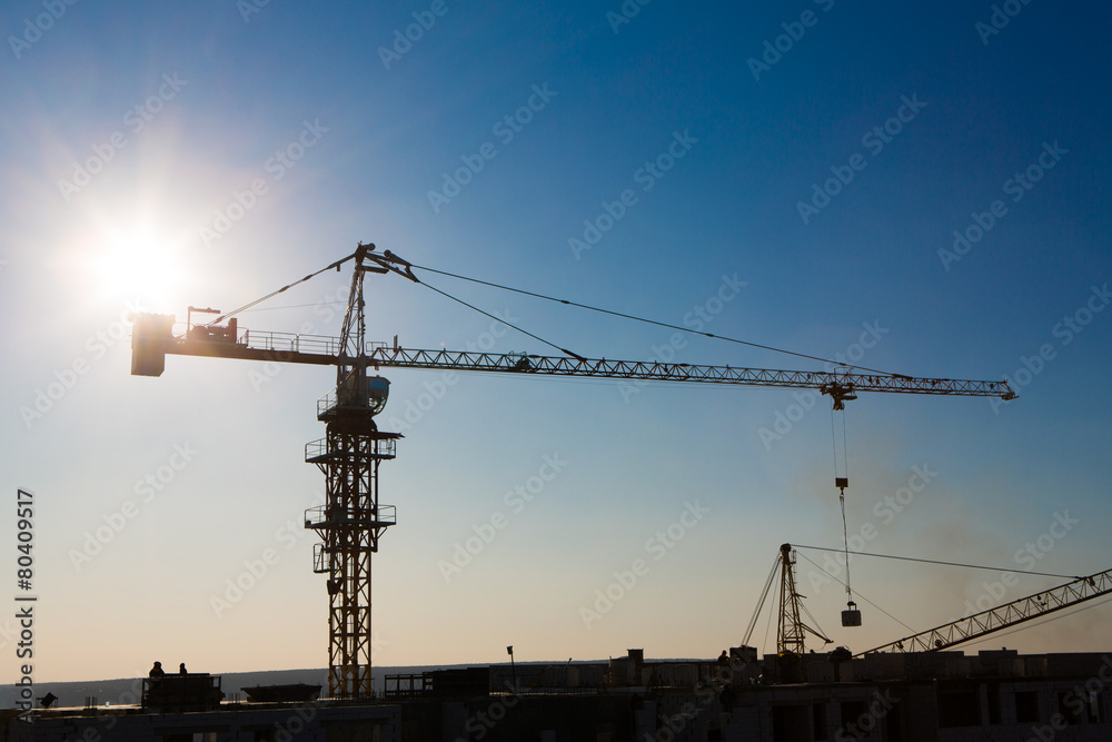 Tower crane silhouette at construction area