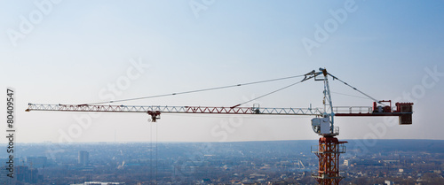 фотографія Tower crane silhouette at construction area