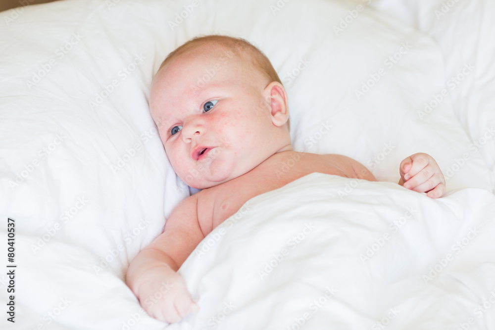 Peaceful newborn baby lying on a bed sleeping Peaceful newborn baby lying on a bed sleeping