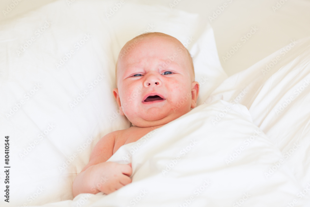 Peaceful newborn baby lying on a bed sleeping Peaceful newborn baby lying on a bed sleeping