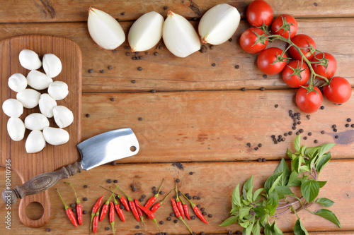 Fototapeta Naklejka Na Ścianę i Meble -  Preparation of Italian food on wood - Mozzarella, onions, tomato