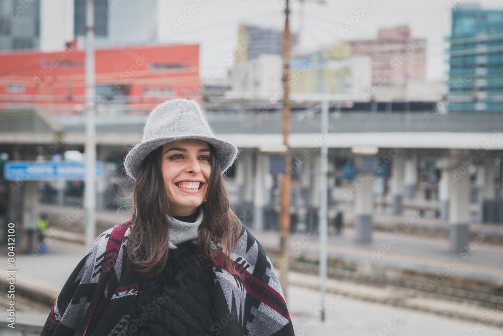 Beautiful young brunette posing in the city streets Beautiful young brunette posing in the city streets