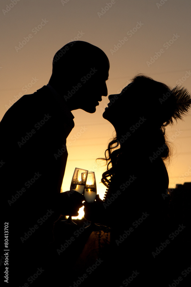 Silhouette of wedding couple at sunset