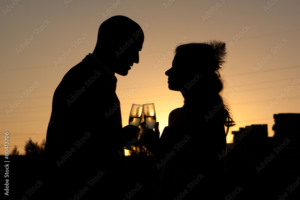 Silhouette of wedding couple at sunset