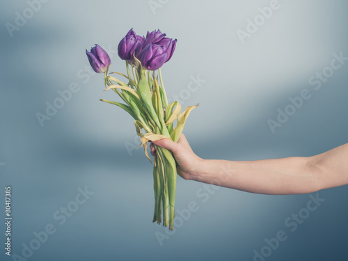 Hand with dead flowers