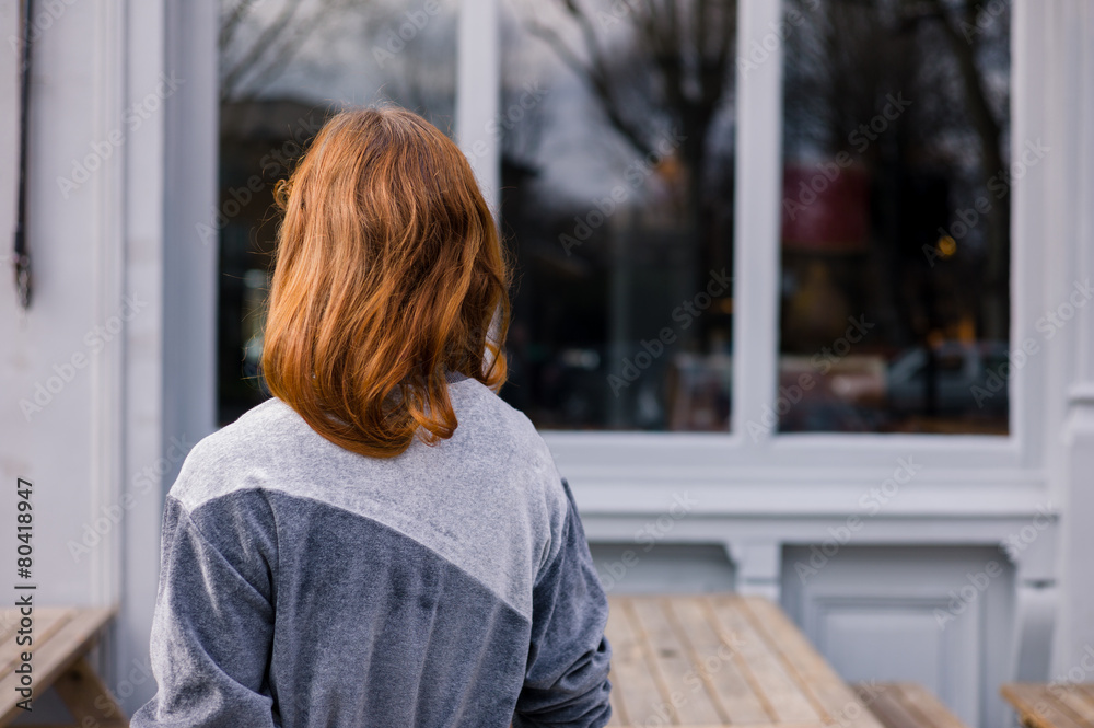 Young woman standing outside pub Young woman standing outside pub