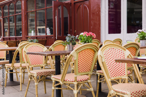 Chairs and tables outside cafe © LoloStock