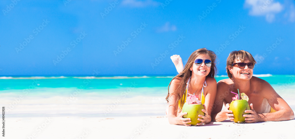 young couple enjoying their time drinking two coconut cocktails young couple enjoying their time drinking two coconut cocktails