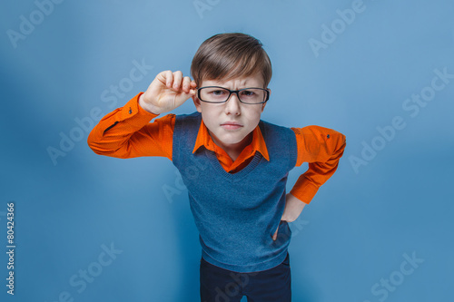 European-looking boy of ten years in glasses frowning, unhappy