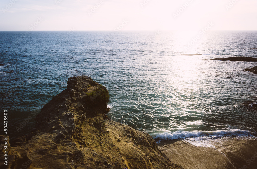 Cliffs and sunset over the Pacific Ocean at Table Rock Beach, in