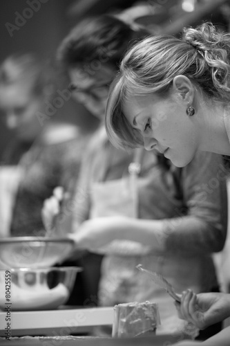 Profile of young woman cooking