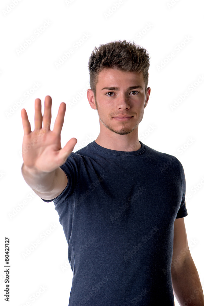 Handsome, seerious young man doing stop sign with his hand Handsome, seerious young man doing stop sign with his hand