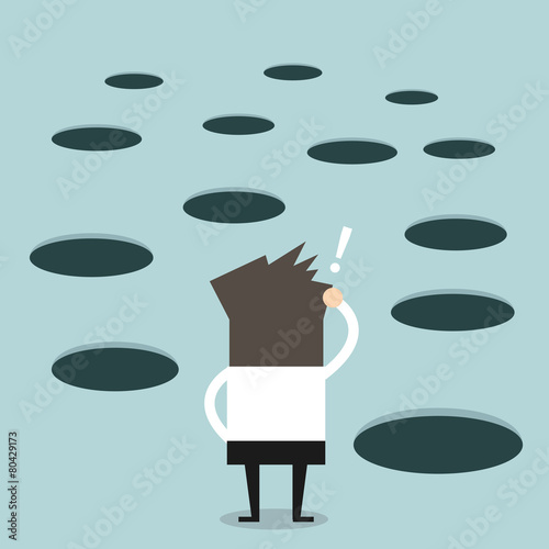 Businessman looks at hole on the ground