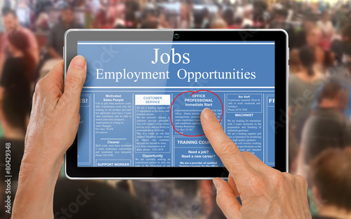 Reading online job ads on a computer tablet -
