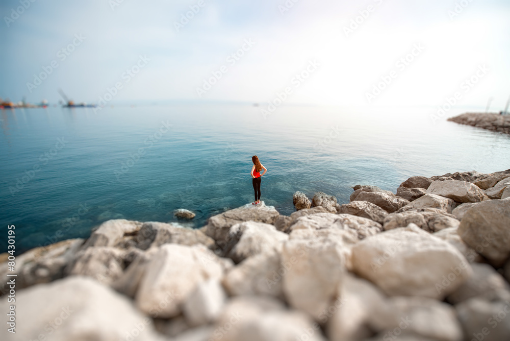 Fototapeta premium Woman on the rocky beach