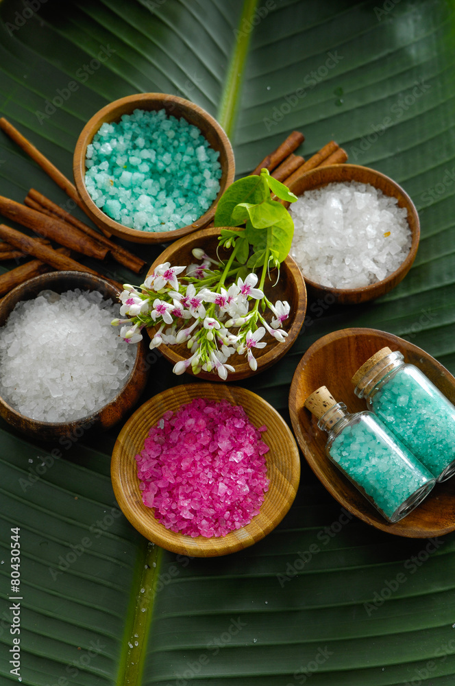 colorful sea salt ,flower in wooden bowl with cinnamon, salt in glass on banana leaf colorful sea salt ,flower in wooden bowl with cinnamon, salt in glass on banana leaf