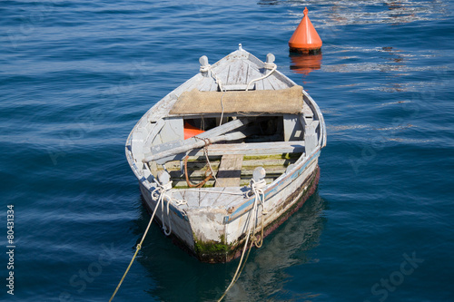 Old wooden boat with oars.