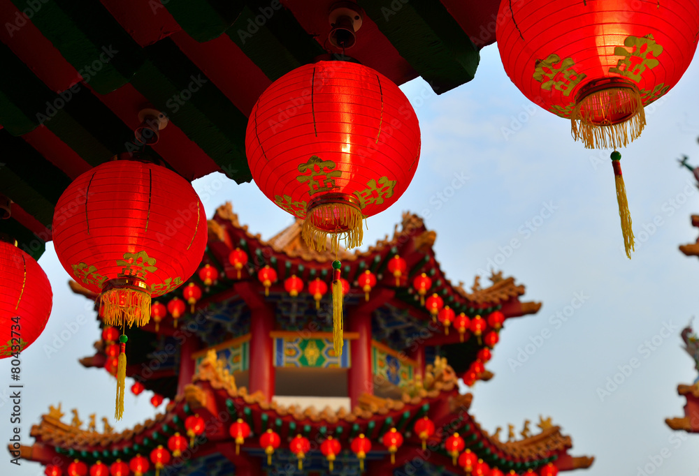 Red Oriental Lanterns. a blurry Chinese gazebo in a background