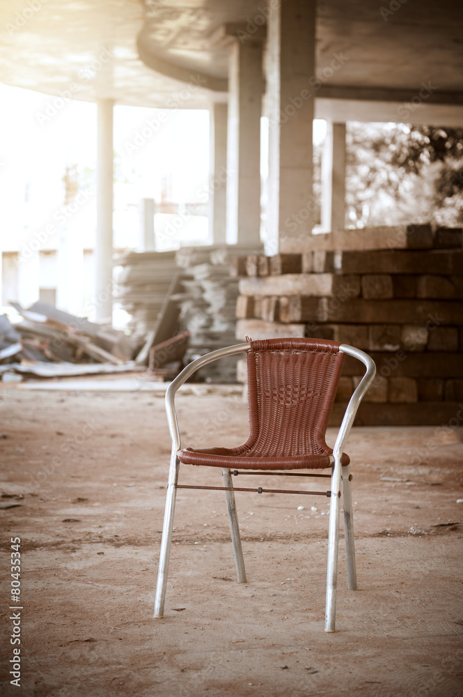 alone old brown chair in construction site