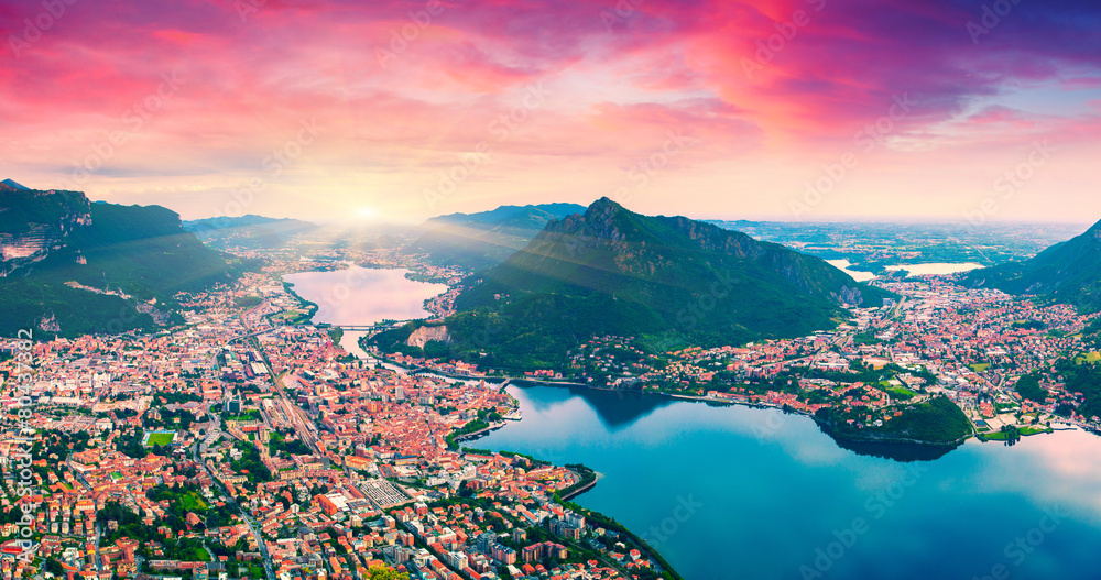 Colorful summer sunrise on the city and lake Lecco