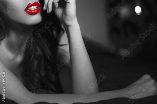 Canvas Print Sexy woman with red lips closeup in selective black and white