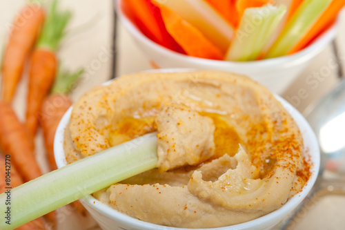 fresh hummus dip with raw carrot and celery