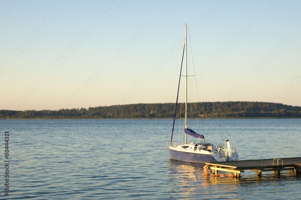 Sailboat moored by jetty