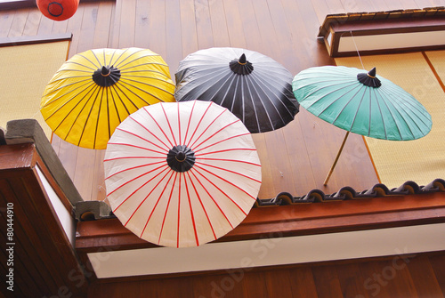 Colorful Japanese umbrella with wooden house background