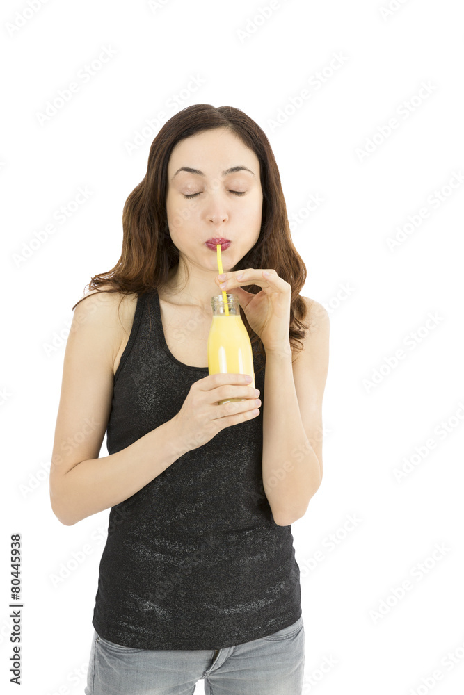 Woman drinking a bottle of banana vanilla smoothie Woman drinking a bottle of banana vanilla smoothie