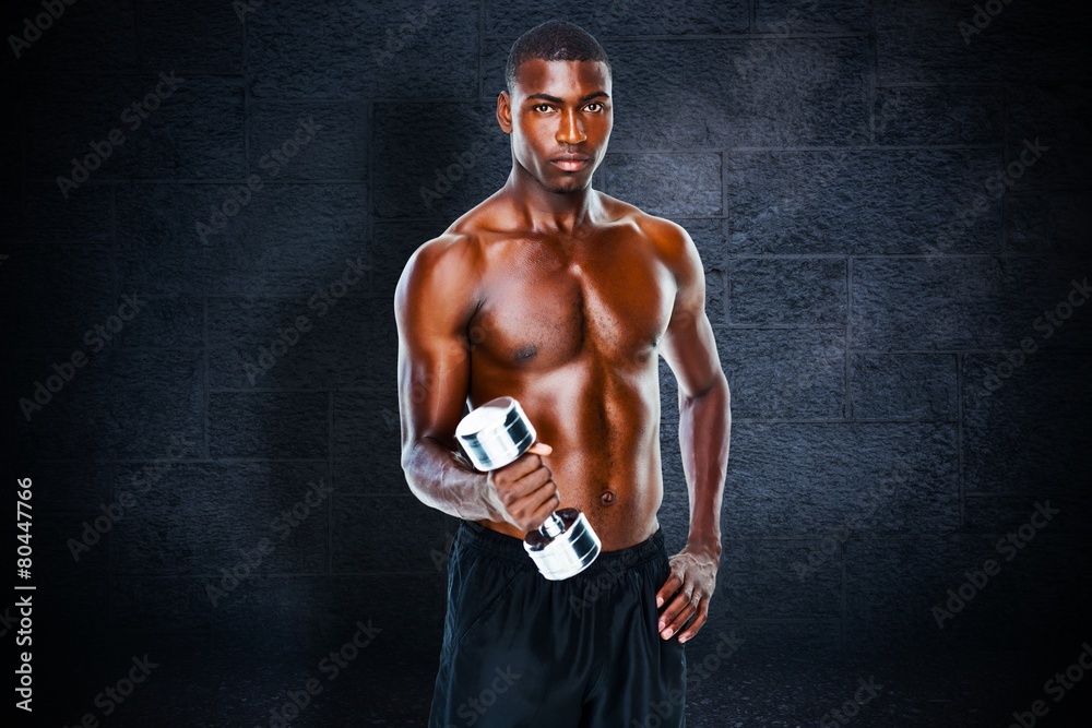 Fit shirtless young man lifting dumbbell