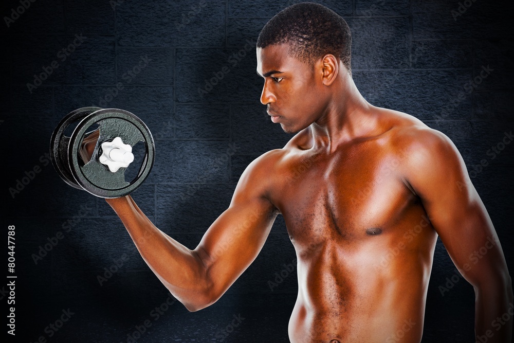 Serious fit shirtless young man lifting dumbbell