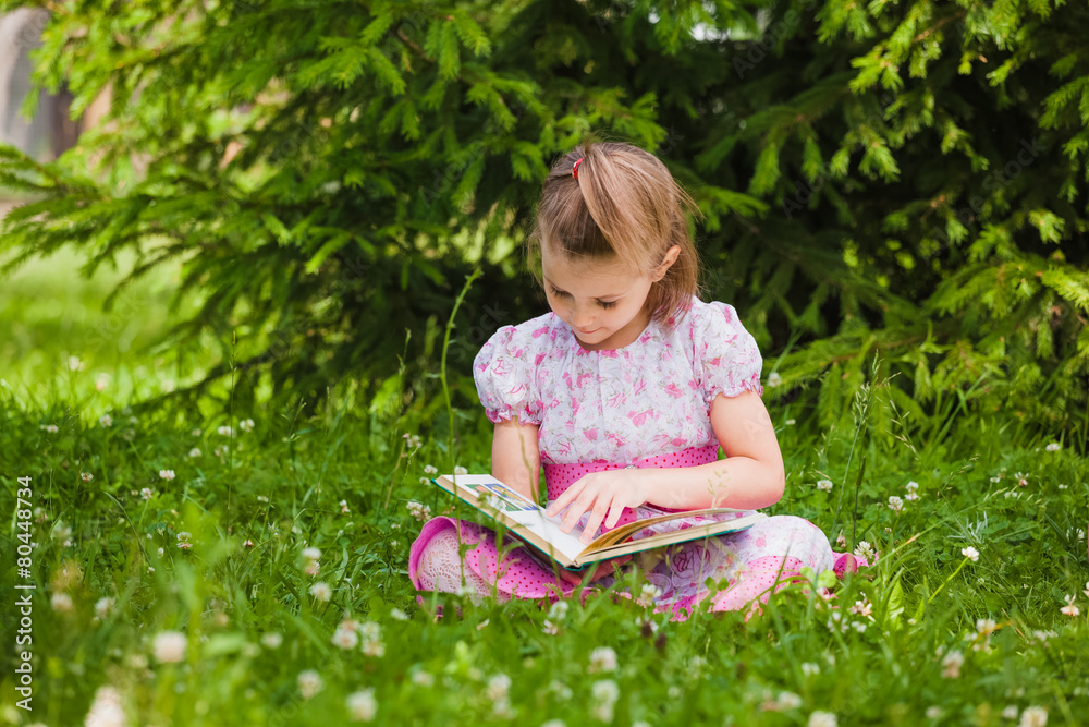 girl is reading on the grass girl is reading on the grass