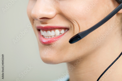 Smiling Female Customer Service Agent Wearing Headset