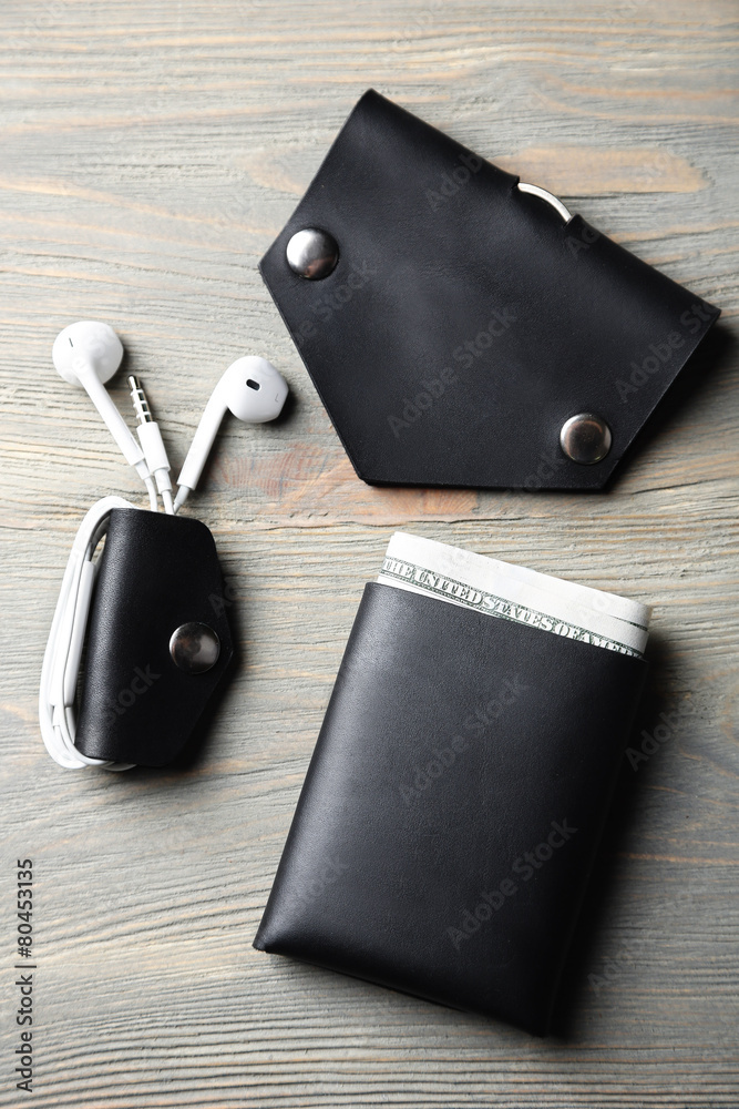 Hand made leather man accessories on wooden background Hand made leather man accessories on wooden background
