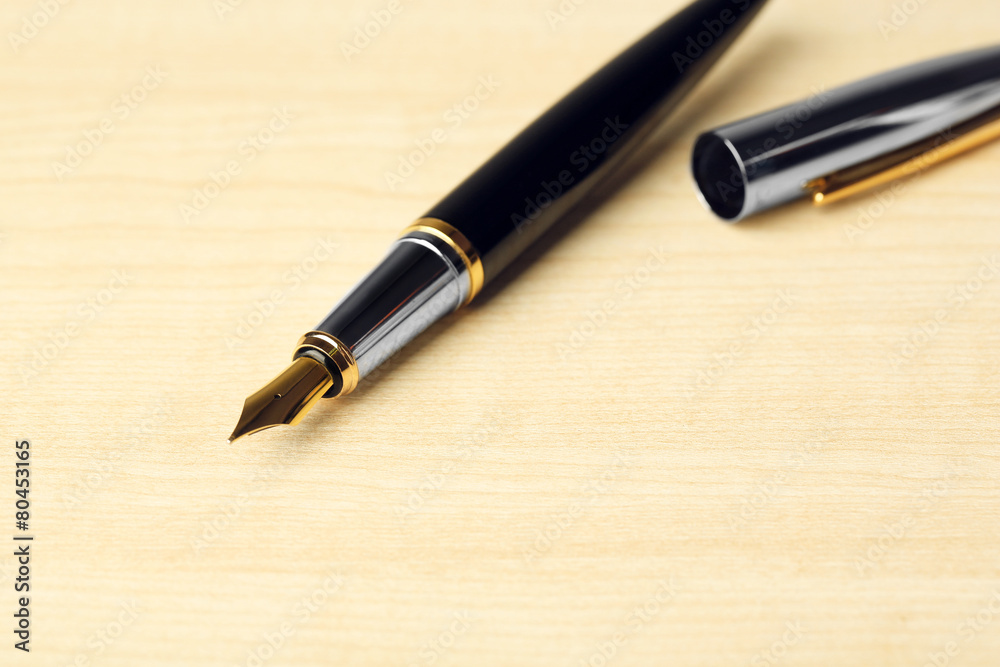 Fountain pen on wooden table background Fountain pen on wooden table background