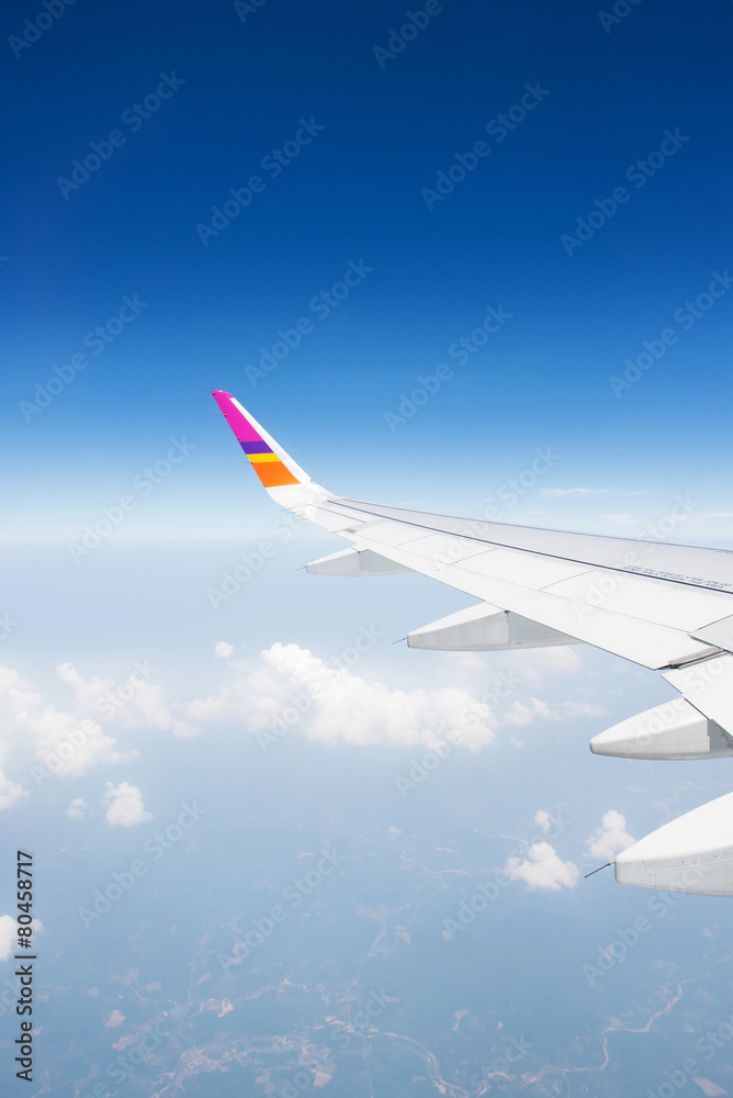 Wing of an airplane flying in the sky Wing of an airplane flying in the sky