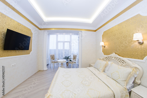 Luxurious bed with cushion in royal bedroom interior