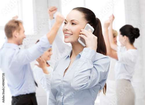 young smiling businesswoman with smartphone